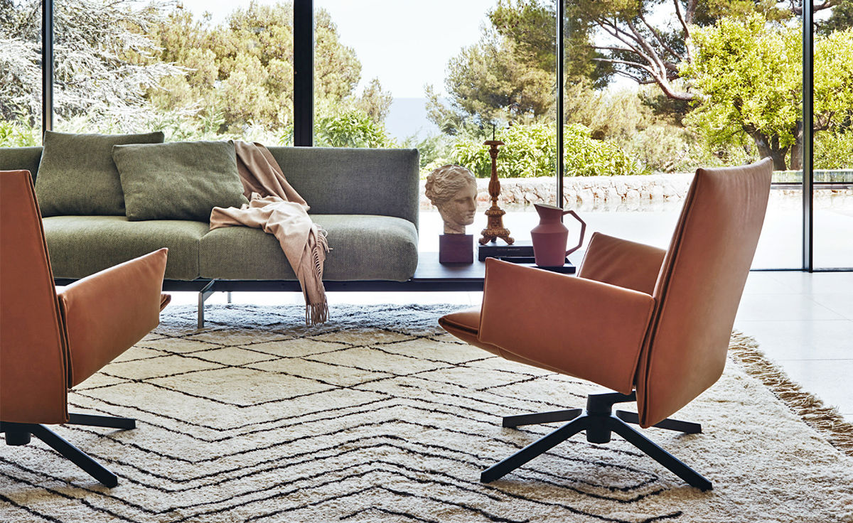 pilot low back lounge chair with upholstered arms